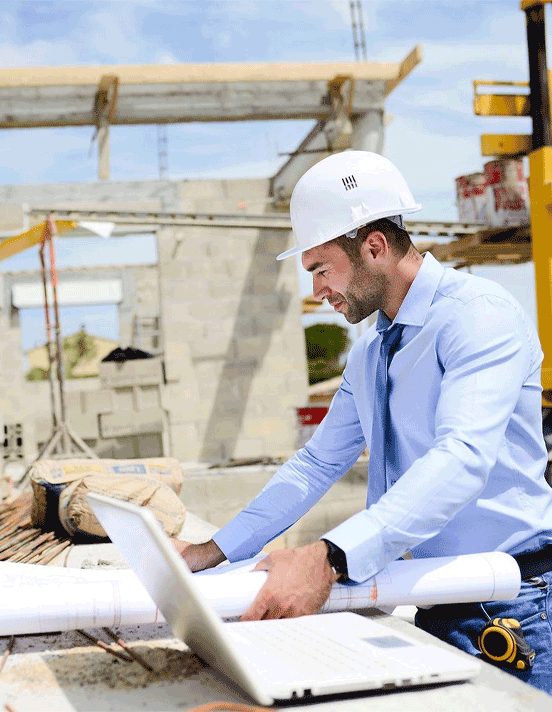 Contractor reviewing blueprints on site